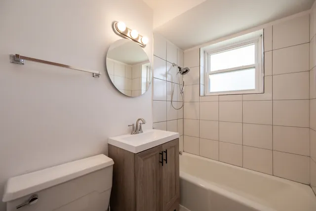 a bathroom with a sink a toilet and bathtub