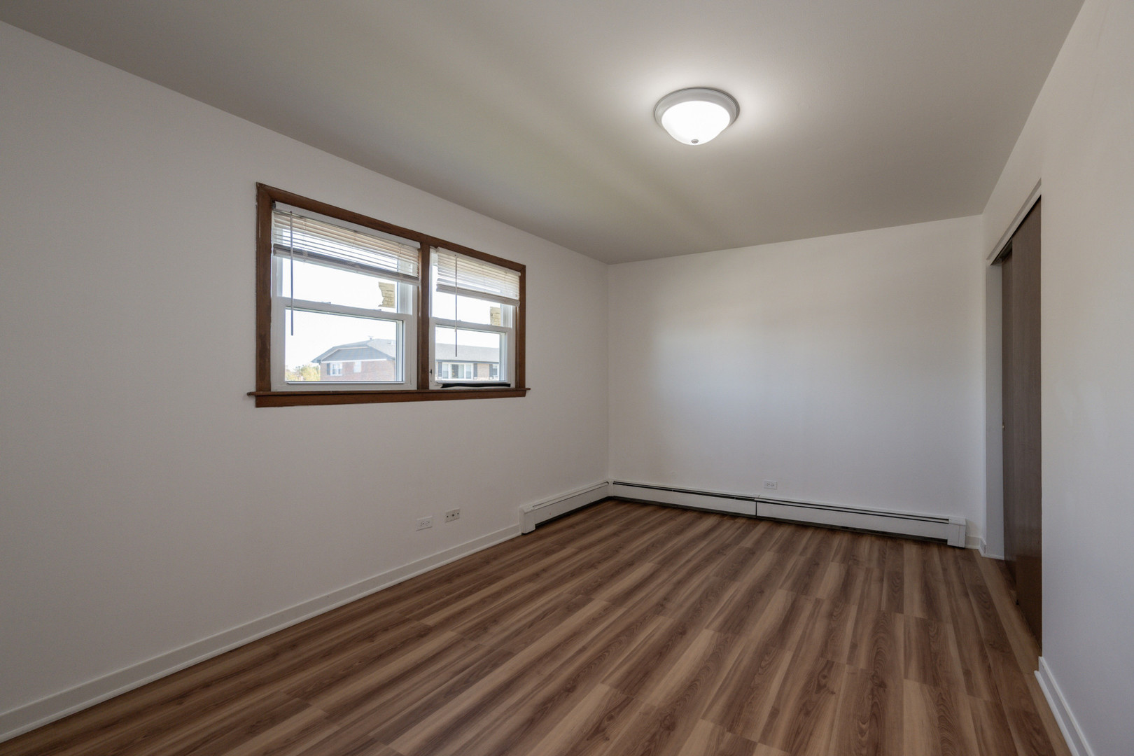 14450 Jefferson Avenue, Unit 2E Orland Park, IL 60462 - Photo 7 of 8 a view of a room with wooden floor and windows