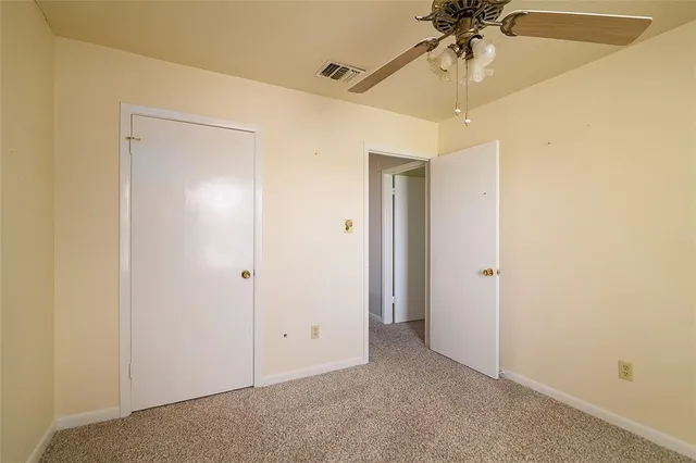 a view of a chandelier fan and a closet