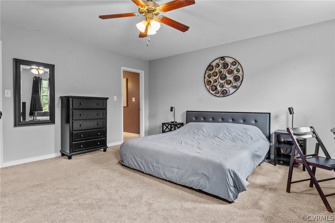 14419 Gatewood Road Dewitt, VA 23840 - Photo 20 of 36 a bedroom with a bed and a chandelier