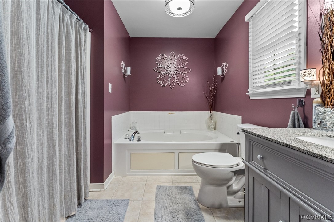 14419 Gatewood Road Dewitt, VA 23840 - Photo 22 of 36 a bathroom with a granite countertop toilet and a bathtub