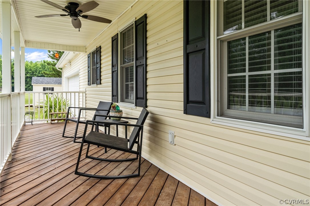 14419 Gatewood Road Dewitt, VA 23840 - Photo 5 of 36 a view of a deck with table and chairs with wooden floor and door