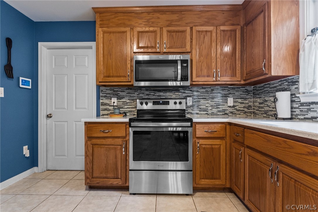 14419 Gatewood Road Dewitt, VA 23840 - Photo 9 of 36 a kitchen with stainless steel appliances granite countertop a stove microwave and refrigerator