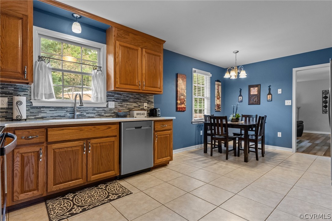 14419 Gatewood Road Dewitt, VA 23840 - Photo 10 of 36 a kitchen with stainless steel appliances granite countertop a stove a sink a dining table and chairs