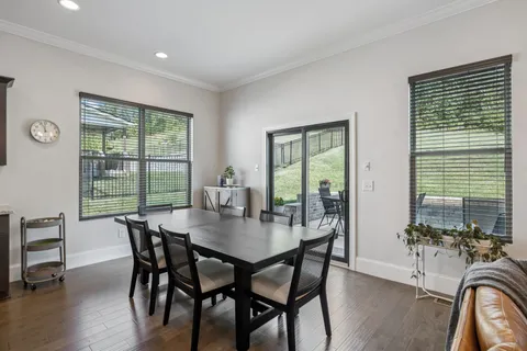 a living room with furniture a flat screen tv and kitchen view