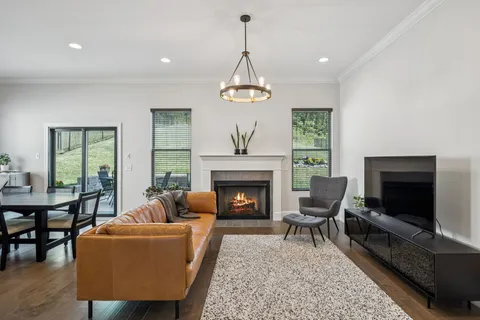 a living room with furniture and kitchen view