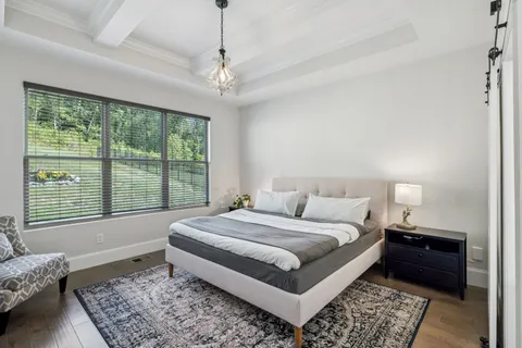 a spacious bedroom with a bed and a window