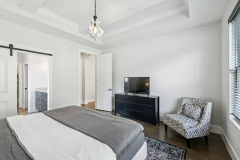 a bathroom with a granite countertop sink a toilet and a mirror