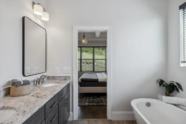 a white bath tub sitting next to a window