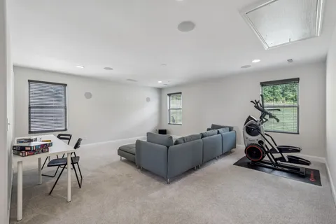 a living room with furniture a air conditioner vent and a window