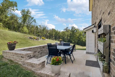 a view of a patio with table and chairs and potted plants