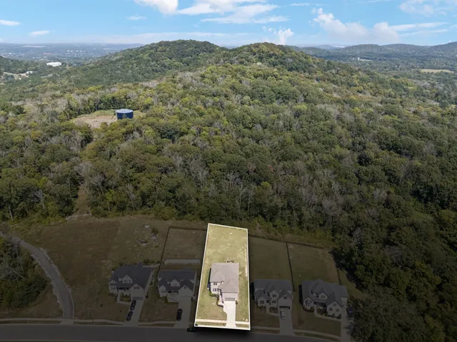 an aerial view of a house with a yard