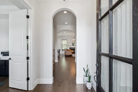 a view of a hallway view with wooden floor and staircase