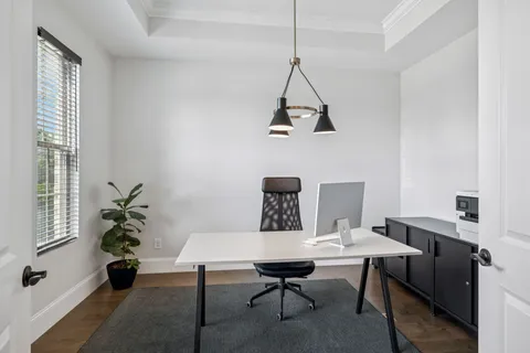 a view of a dining room with a table and chairs