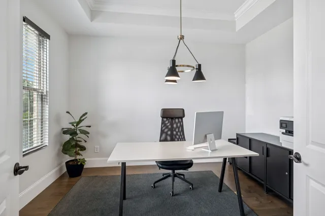 a view of a dining room with a table and chairs