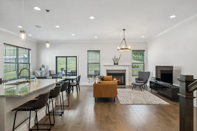 a living room with fireplace furniture and a wooden floor