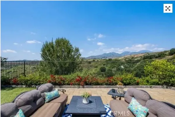 a view of a couches in a patio with a yard