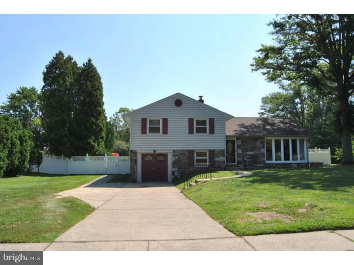 1141 Oliver Road Huntingdon Valley, PA 19006 - Photo 1 of 25 a front view of a house with a yard and trees