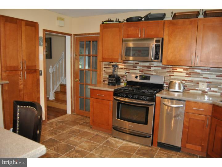 1141 Oliver Road Huntingdon Valley, PA 19006 - Photo 11 of 25 a kitchen with stainless steel appliances granite countertop a stove a microwave and a refrigerator