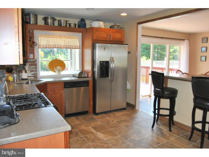 1141 Oliver Road Huntingdon Valley, PA 19006 - Photo 12 of 25 a kitchen with stainless steel appliances granite countertop a refrigerator and a stove top oven