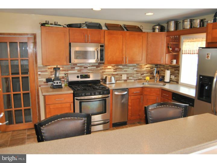 1141 Oliver Road Huntingdon Valley, PA 19006 - Photo 13 of 25 a kitchen with stainless steel appliances a stove sink and refrigerator
