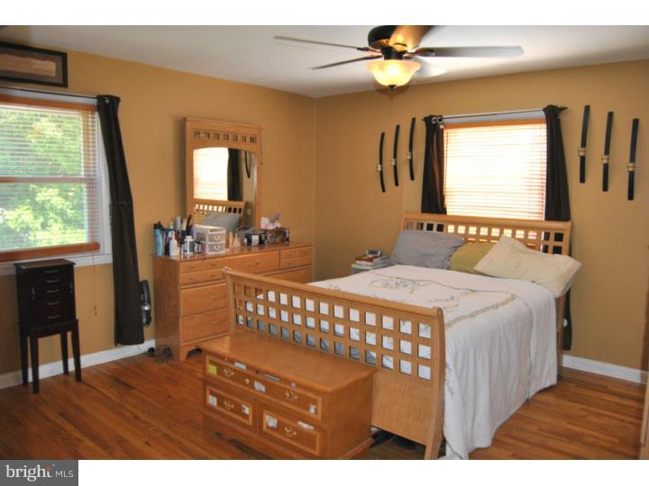 1141 Oliver Road Huntingdon Valley, PA 19006 - Photo 18 of 25 a bedroom with a bed a dresser next to a window