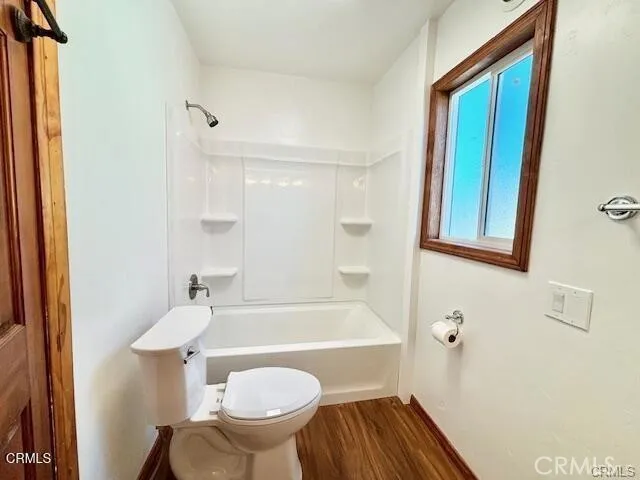 a bathroom with a sink a toilet a mirror and bathtub