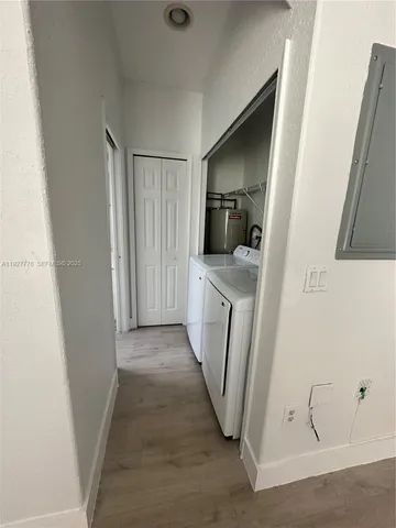 a view of a kitchen from a hallway
