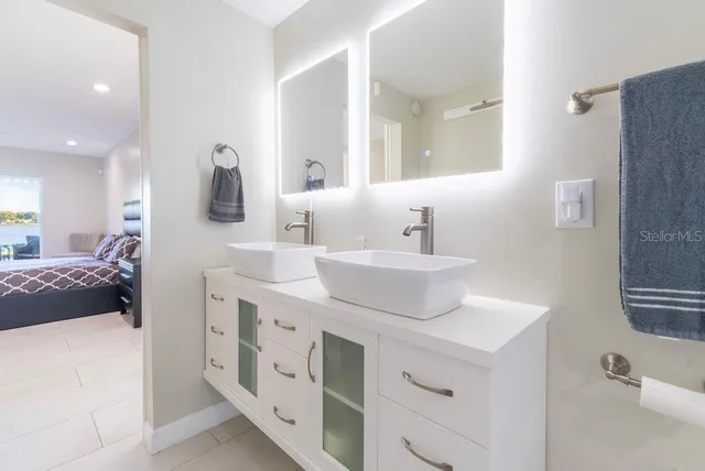 a bedroom with a large bed and a large window