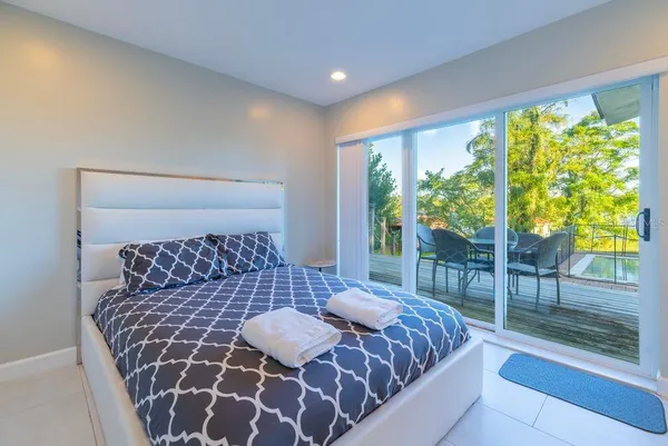 a spacious bedroom with a large bed and a large window