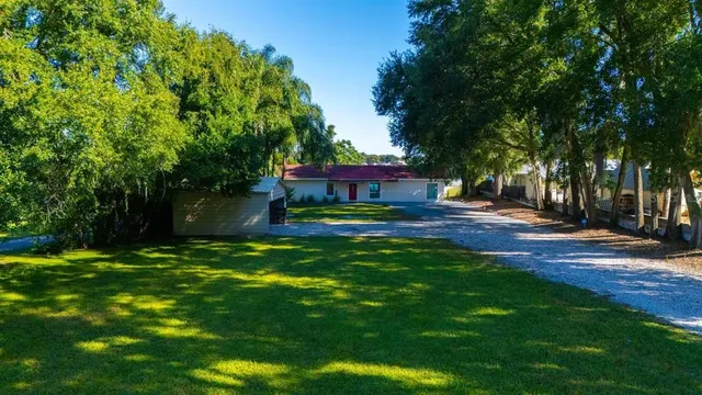 a view of a chairs and table in the patio with a lake view