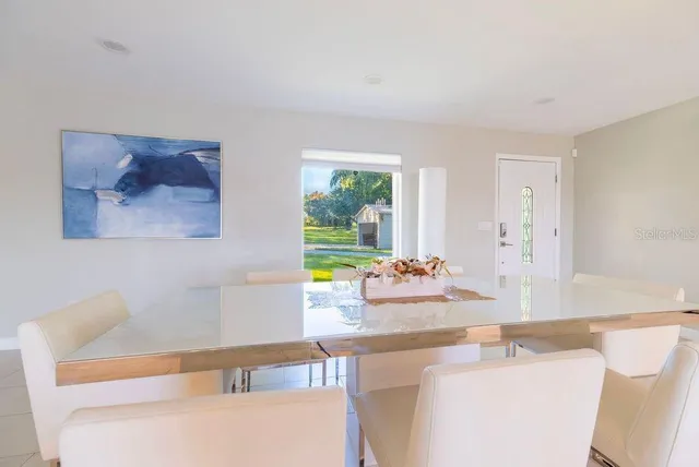 a spacious bedroom with a large bed and a large window