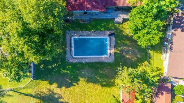 a aerial view of a house with a yard basket ball court and outdoor seating