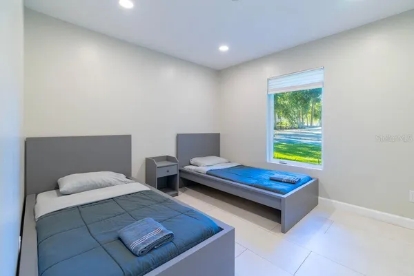 a bedroom with a bed and window