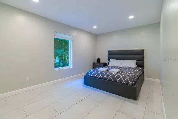 a white bath tub sitting in a bathroom next to a window