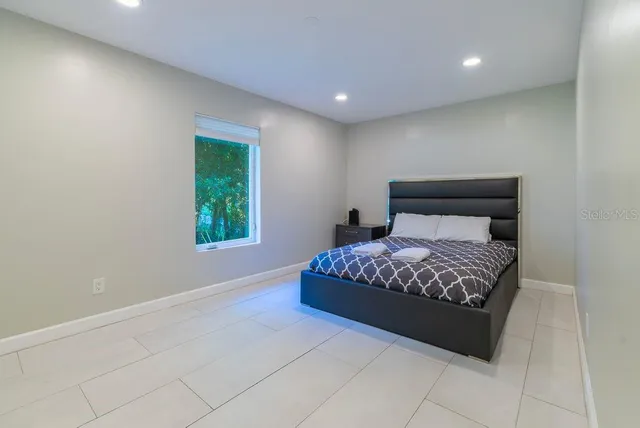 a white bath tub sitting in a bathroom next to a window