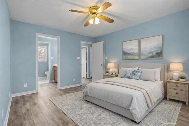 a bathroom with a granite countertop sink a toilet and a mirror