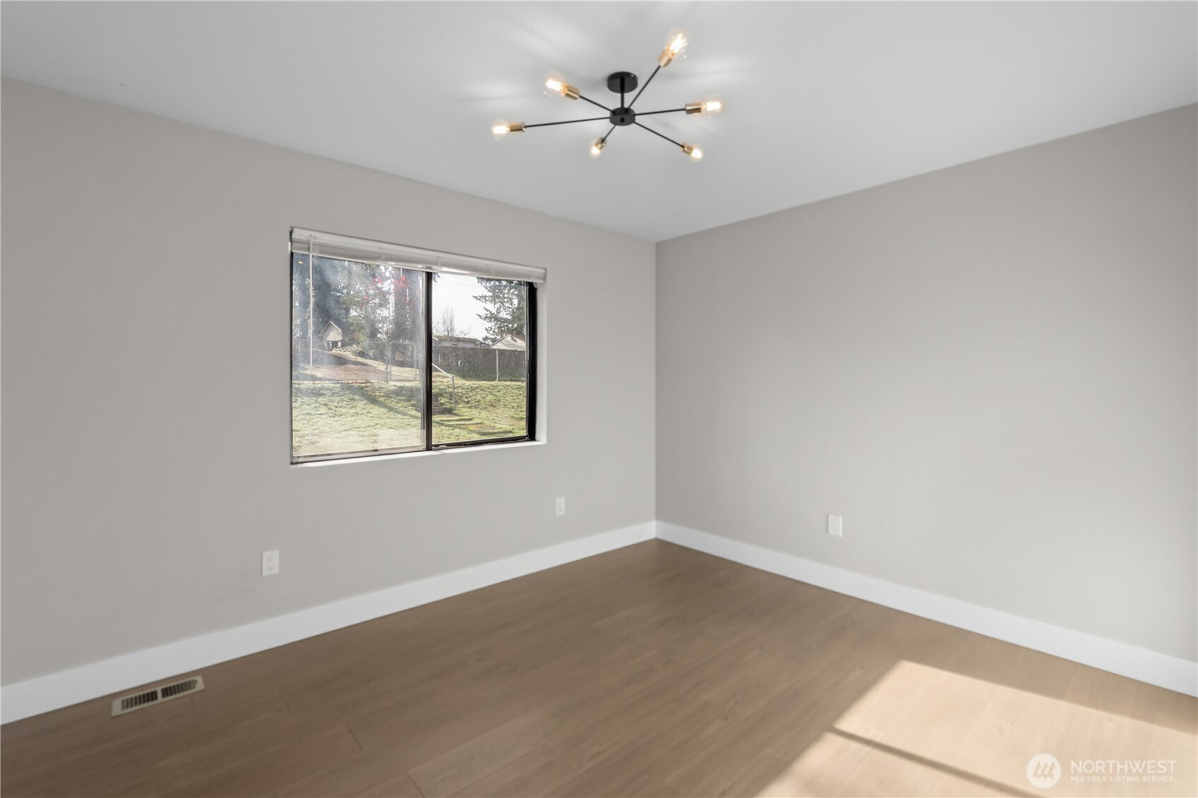 625 173rd Street South Spanaway, WA 98387 - Photo 21 of 35 an empty room with windows and ceiling fan