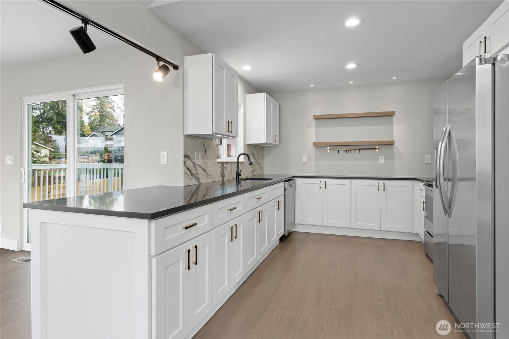 625 173rd Street South Spanaway, WA 98387 - Photo 7 of 35 a kitchen with granite countertop a sink and cabinets