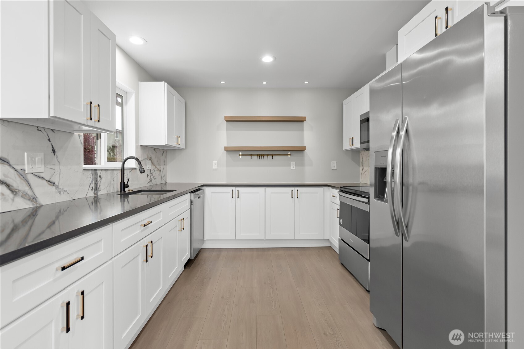 625 173rd Street South Spanaway, WA 98387 - Photo 8 of 35 a kitchen with cabinets and stainless steel appliances