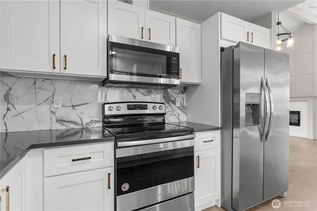 a view of a kitchen with a stove and a refrigerator