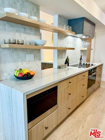 a kitchen with stainless steel appliances a stove and cabinets