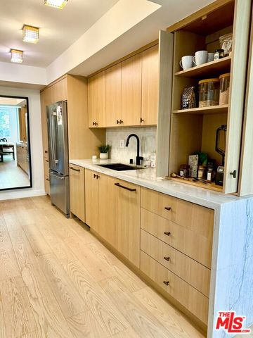 a kitchen with stainless steel appliances granite countertop a sink and cabinets