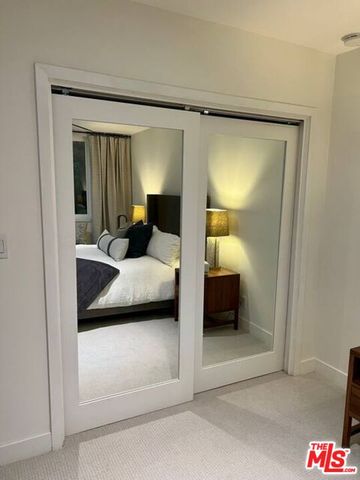 a bedroom with a bed and a walk in closet