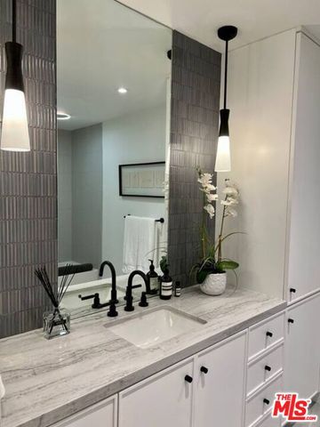 a bathroom with a double vanity sink and a mirror