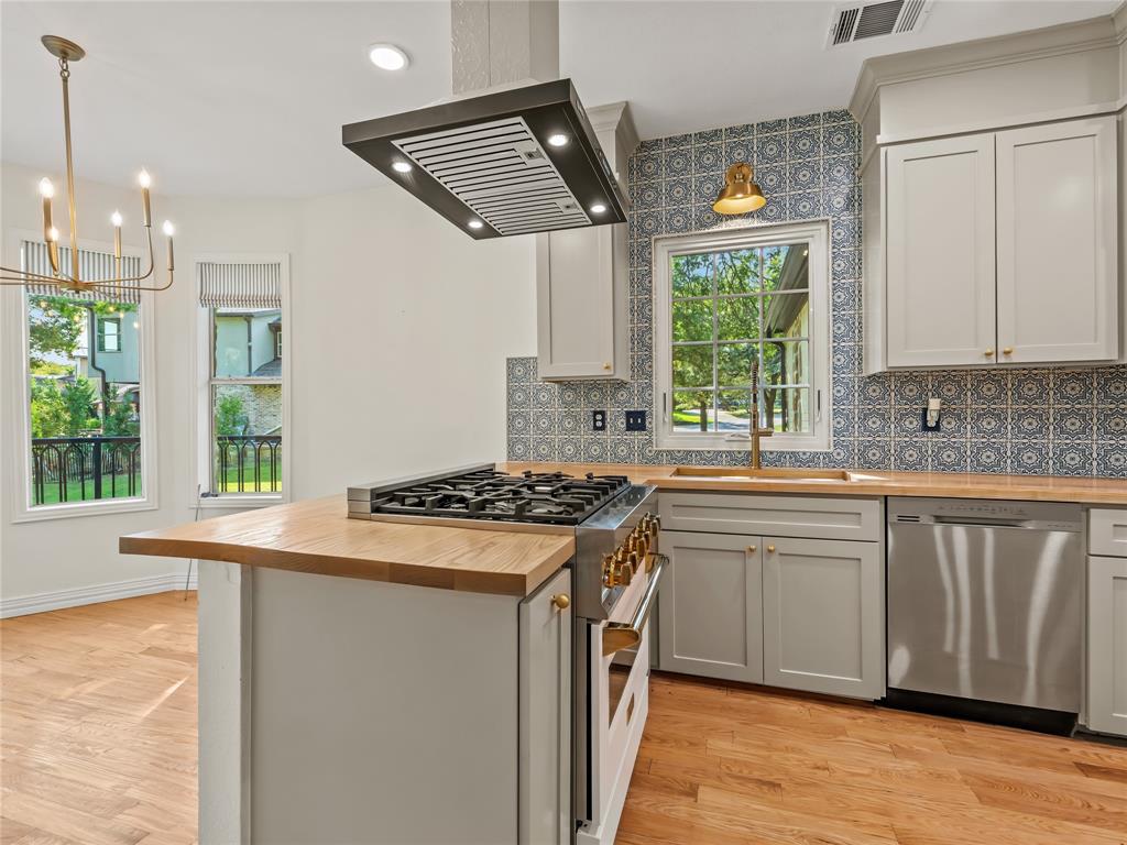 153 Meadowcreek Road Coppell, TX 75019 - Photo 12 of 35 Kitchen featuring butcher block counters, range with gas cooktop, tasteful backsplash, dishwasher, and light wood-style floors