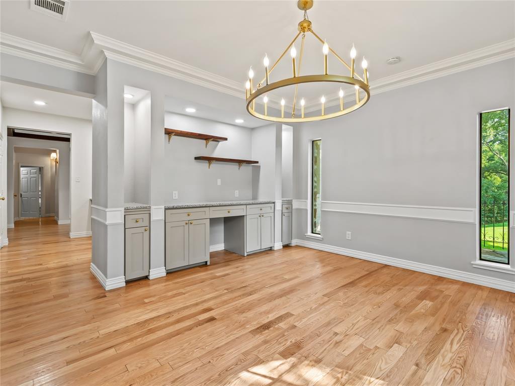 153 Meadowcreek Road Coppell, TX 75019 - Photo 17 of 35 Kitchen with open shelves, light wood-style floors, crown molding, suspended lighting, and built in study area