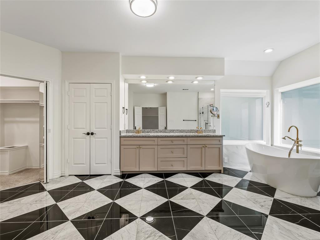 153 Meadowcreek Road Coppell, TX 75019 - Photo 23 of 35 Bathroom with a soaking tub, double vanity, a spacious closet, recessed lighting, and vaulted ceiling