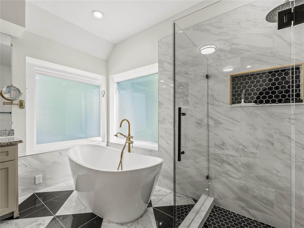 153 Meadowcreek Road Coppell, TX 75019 - Photo 25 of 35 Full bath with a soaking tub, a marble finish shower, vanity, marble finish flooring, and lofted ceiling