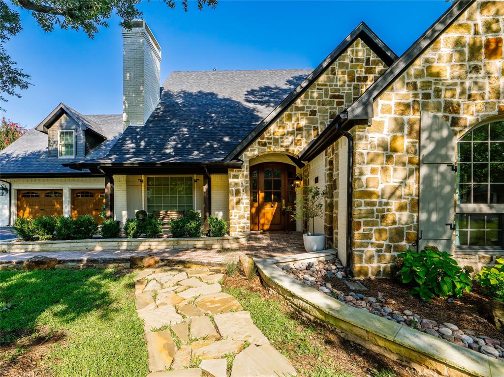 153 Meadowcreek Road Coppell, TX 75019 - Photo 32 of 35 Tudor home featuring stone siding, a chimney, and covered porch